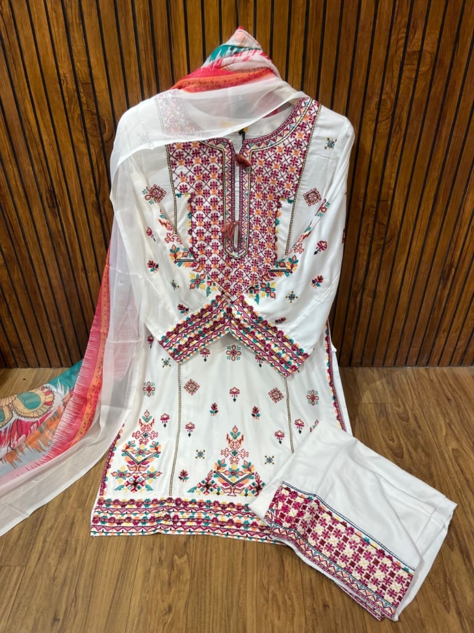 Elegant white cotton suit featuring vibrant multicolor heavy embroidery work on the neckline