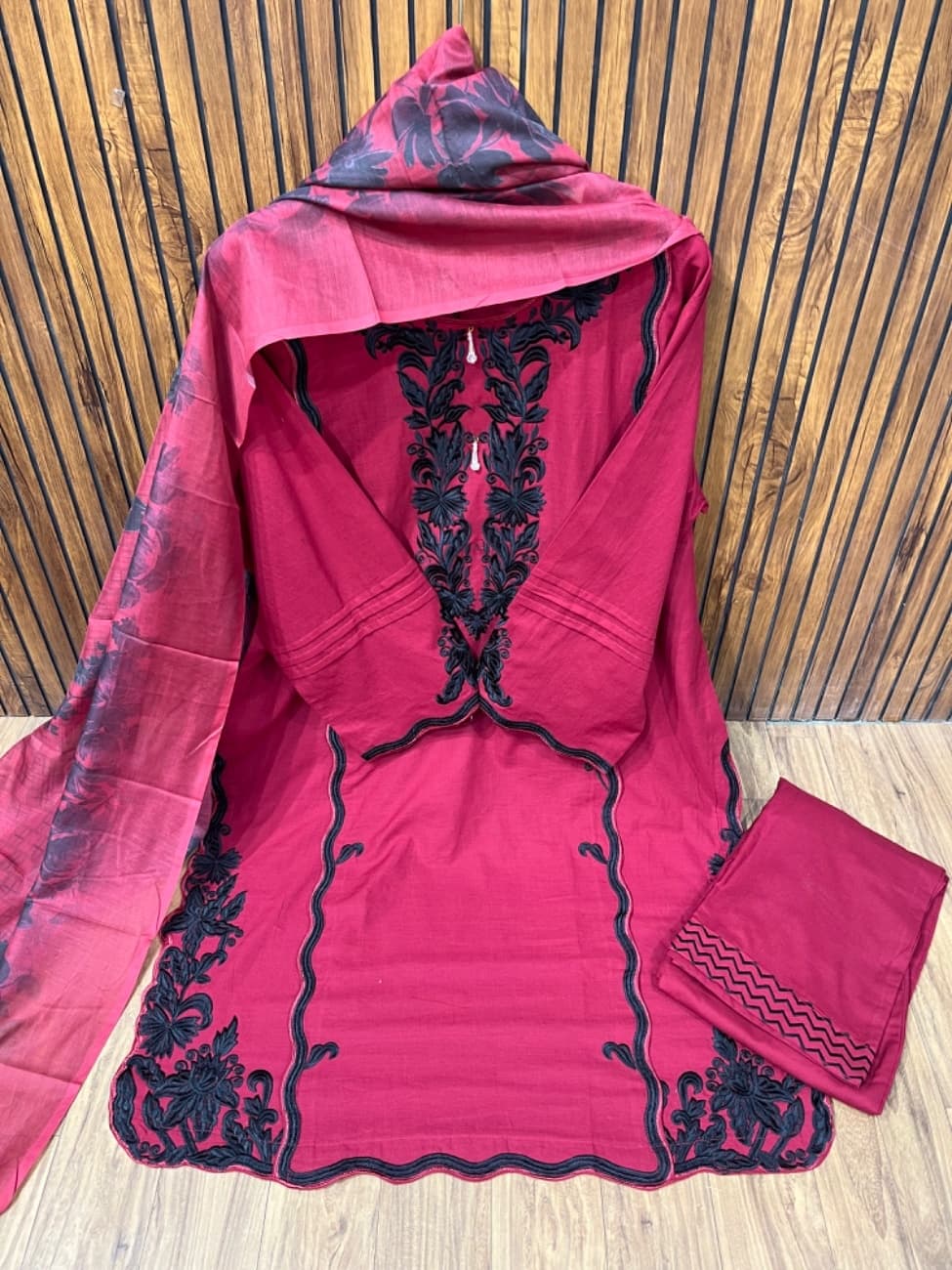 This stunning deep wine-red suit features elegant black heavy embroidery